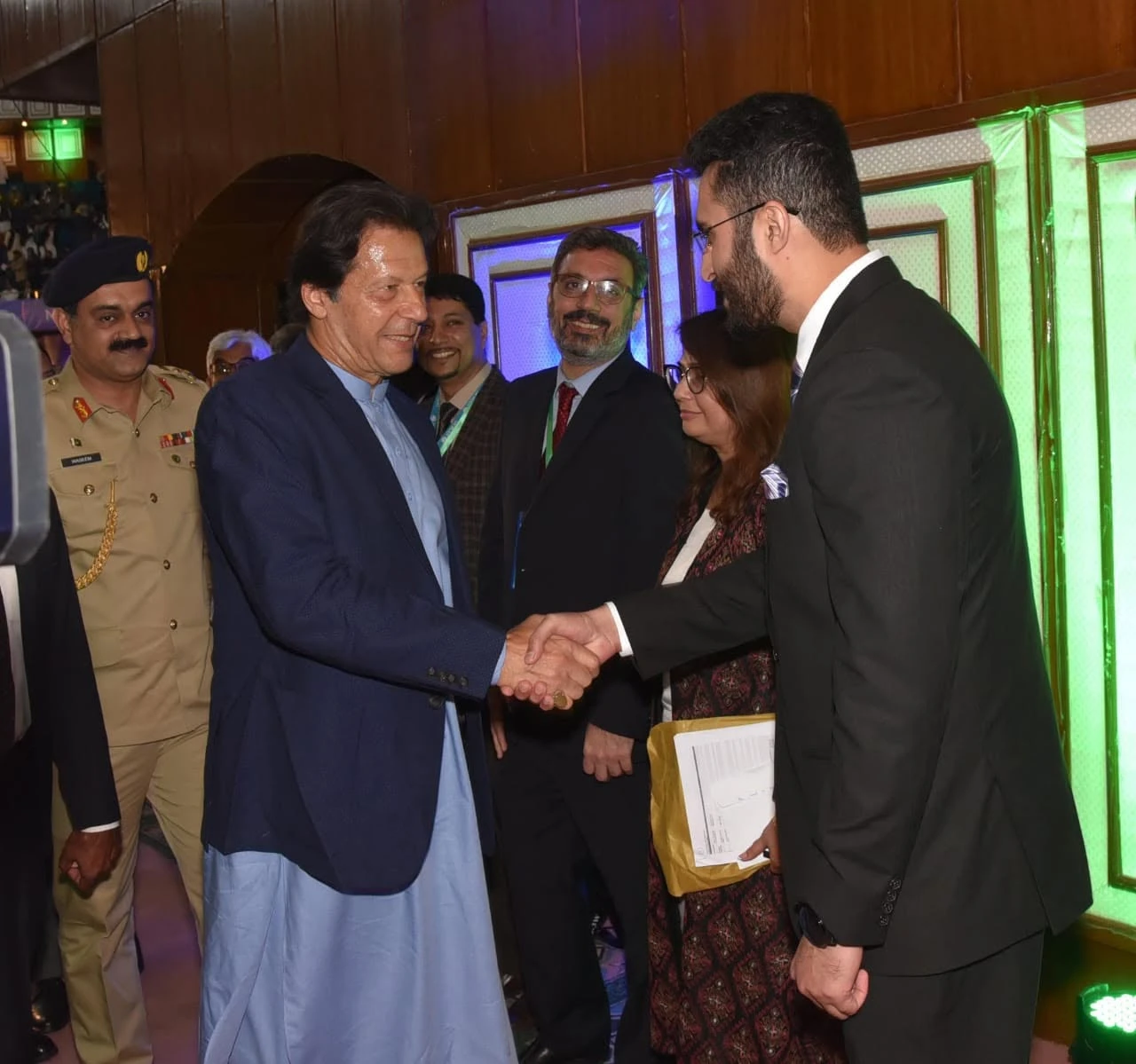 Ghayoor Zafar shaking hands with then Prime Minister Imran Khan at a Clean Green Pakistan event